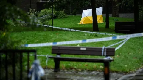 Getty Images A police tent on Grimsel Path on the Brandon Estate