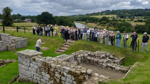 Bill Griffiths Dr Nick Hodgson explaining the East Gate at Chesters