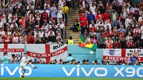 Robbie Jay Barratt/AMA/Getty Phil Foden in front of English flags in Qatar