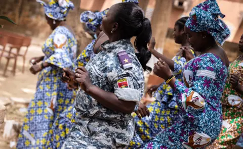 AFP Female wardens and female detainees dance together at a prison in Ouagadougou, Burkina Faso - Tuesday 8 March 2022