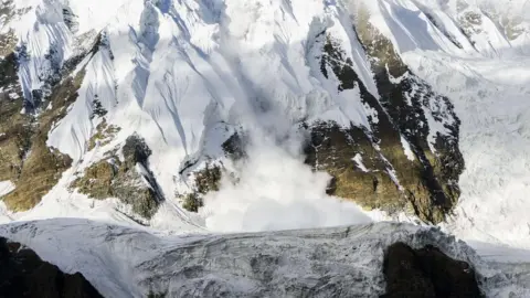 Frank Bienewald/Getty An ice avalanche is shooting down an icy rock slope
