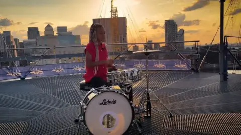 Young Voices Nandi Bushell drumming on top of the O2 in London