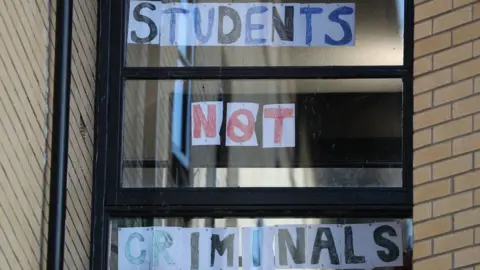 PA Media A sign reading "students not criminals" at Murano Street Student Village in Glasgow