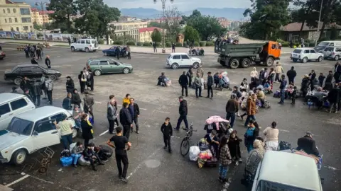 Getty Images Ethnic Armenians wait to be evacuated from Stepanakert on September 26, 2023.