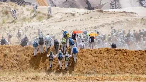 Getty Images Activists run into the grounds of the mine