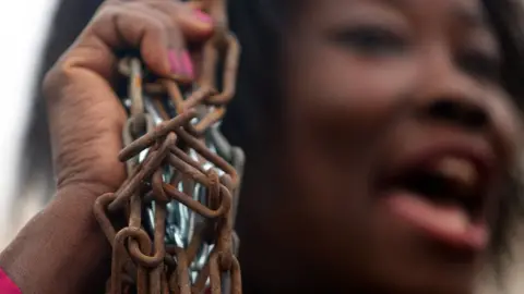 EPA A migrant protests in opposition to the slavery of refugees in Athens, Greece - Saturday 2 December 2017