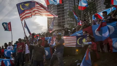 Getty Images Supporters of Mahathir Mohamad, wait for him to be sworn in as Malaysian prime minister May 10, 2018