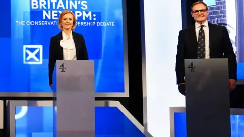 PA Media Tom Tugendhat and Liz Truss stand side by side at their podiums during a Channel 4 leadership debate