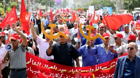EPA Members of the Iraqi Communist party shout slogans and carry communist flags and the communist symbols during a demonstration to mark Labour Day, in central Baghdad, Iraq, 01 May 2018.