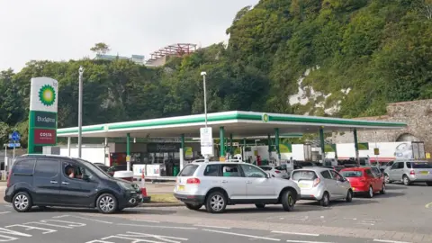 PA Media Cars queue at a petrol station in Dover