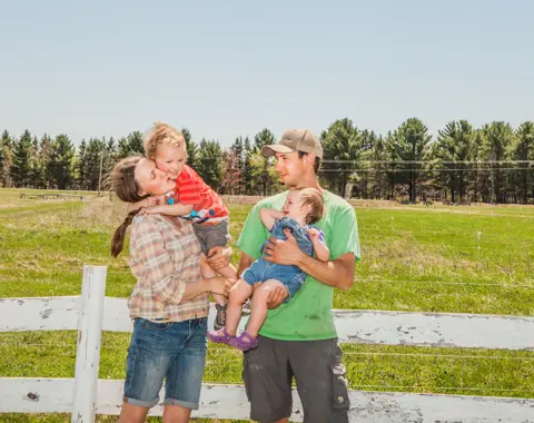 Ian Brown Johnson family standing outdoors against a fence