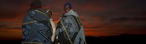 Getty Images Men in Lesoth at dawn wearing traditional blankets