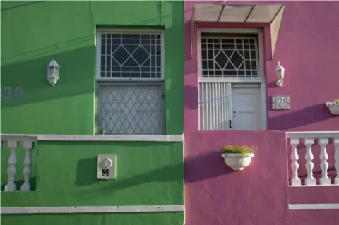 EPA Two conjoined houses are pictured. One is mint green, the other a powdery pink.