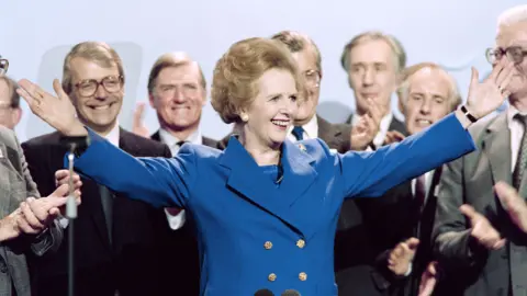 Getty Images Margaret Thatcher surrounded by male colleagues at the 1989 party conferences