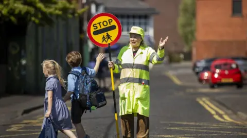 Liam McBurney/PA Lollipop lady Veronica Hammersley