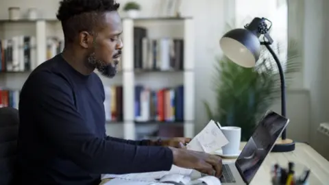 Getty Images Man calculating budget and finances