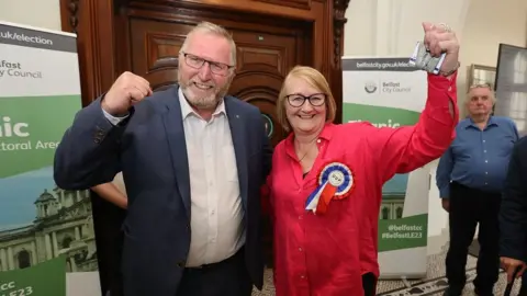 PA/Liam McBurney Ulster Unionist Party candidate Sonia Copeland celebrates winning a seat with party leader Doug Beattie during the Northern Ireland council elections at Belfast City Hall.