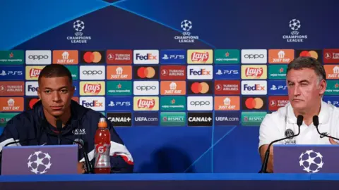 Getty Images Mbappe (L) and Paris Saint Germain's head coach Christophe Galtier (R) attend a press conference