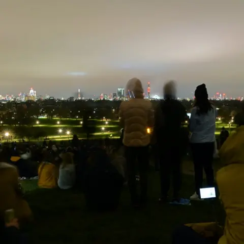 Helen Chambers People gathered to look at the London skyline