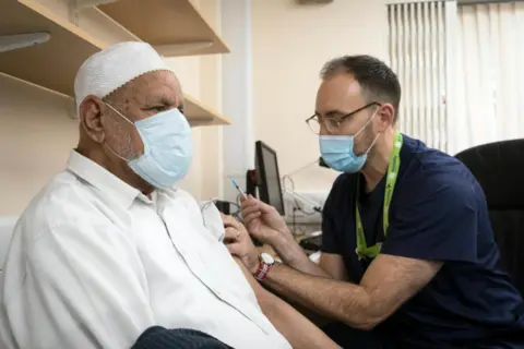 Bob Smith / NHS Mohammed Bostan, 95, is vaccinated in December