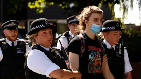 Reuters Person being led away police