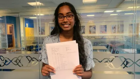 BBC Brintha Yasodaran holding her results