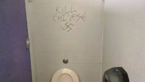 Poppy Wang Graffiti on a wall says "kill Chinese" alongside a swastika