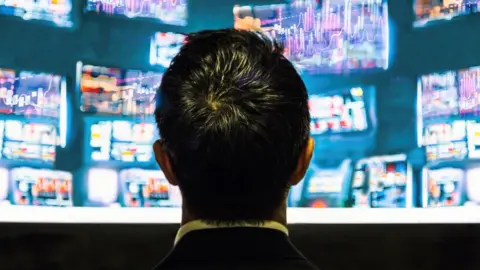 Getty Images Man looking at stocks