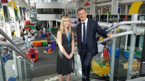 UK government Alun Cairns and Tracy Marsh standing inside Techniquest science centre