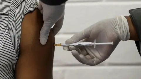 Reuters A volunteer receives an injection from a medical worker during the country's first human clinical trial for a potential vaccine against the novel coronavirus, at the Baragwanath hospital in Soweto, South Africa, June 24, 2020.