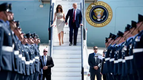 Getty Images Donald and Melania Trump arrive in the UK in 2018