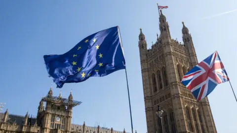 Bloomberg Creative EU and UK flags fly outside the Houses of Parliament in London