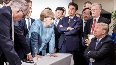 Getty Images German Chancellor Angela Merkel deliberates with US president Donald Trump