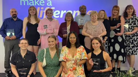 Back row (l to r): Mohammed Amrez, Ebony Stovell, Pixi Travers-Stovell, Kim Vickers, Naushad Ali, Sandra Ursell, Ita Hobell, Debbie Newton and Julie Wheelhouse. Front row: Lucy Giuliano, Maggie Walker, Lyn Adcock, Molly Preston- Davies