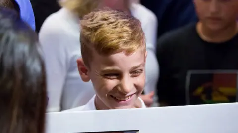Reuters Emad Mishko Tammo, twelve-year-old Yazidi boy,smiles as he is reunited with his family
