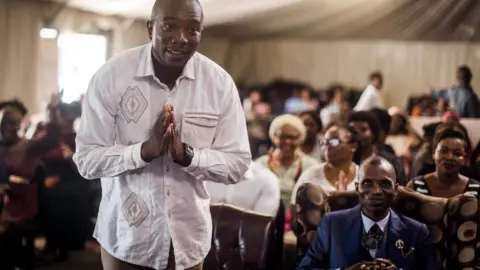 AFP Mmusi Maimane greets the congregation at the Abundant Life Church in Kwamashu township outside of Durban on 17 March 2019, while on the campaign trail.