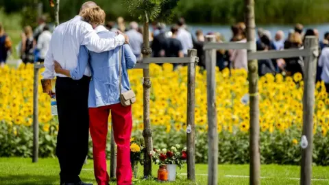 Getty Images Relatives attend the unveiling of the National Monument for the MH17 victims in Vijfhuizen, on July 17, 2017