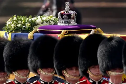 EPA The coffin containing the body of Britain's Queen Elizabeth II, draped in the royal standard with the Imperial State Crown on top, is transported on a gun carriage of the King's Troop Royal Horse Artillery from Buckingham Palace to Westminster Hall followed by members of the royal family in London, Britain, 14 September 2022.