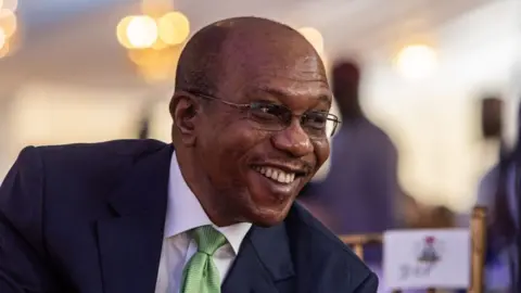 Getty Images Godwin Emefiele, governor of Nigeria's central bank, during the commissioning ceremony of the Dangote Industries Ltd. oil refinery and fertilizer plant site in the Ibeju Lekki district of Lagos, Nigeria, on Monday, May 22, 2023