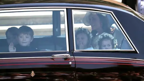 Getty Images Duchess of Cambridge arrives with page boys Prince George (L) and Jasper Dyer and bridesmaids Princess Charlotte (R) and Florence van Cutsem. Jasper and Florence are Prince Harry's godchildren