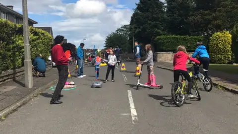 City of Edinburgh Council Children playing games and cycling in the street