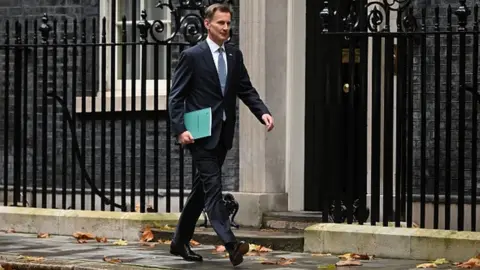Getty Images Chancellor Jeremy Hunt leaves Downing Street in central London on his way to make a full budget statement in the House of Commons