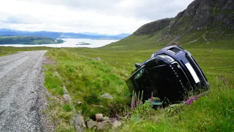 BBC A car crashes off the single-track road