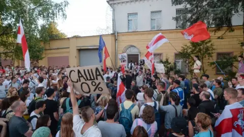 EPA Opposition supporters take part in a protest in front of the prison where Sergei Tikhanovsky is held in Minsk