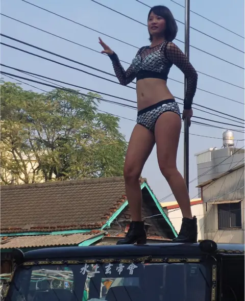 AFP/Getty Images This picture taken on 3 January 2017 shows a pole dancer performing on top of a jeep during the funeral procession of former Chiayi City county council speaker Tung Hsiang in Chiayi City, southern Taiwan.