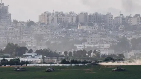 Reuters Israeli tanks manoeuvre inside the Gaza Strip, as seen from southern Israel (29 October 2023)