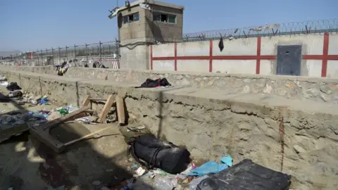 Getty Images A suitcase and backpacks of Afghan people who were waiting to be evacuated are seen at the site of the attack, which killed scores of people including 13 US troops, at Kabul airport