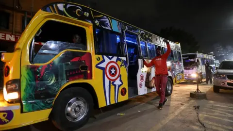 Daniel Irungu/Shutterstock A Kenyan calls for passengers at a bus station to board public transport in Nairobi, Kenya, 19 September 2023.