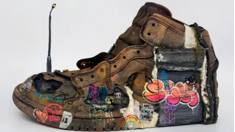 Stella Stockbridge The shoe design created by Stella Stockbridge which shows graffiti painted onto a trainer