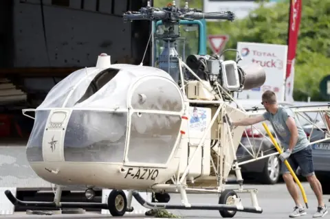 EPA Investigators transport an Alouette II helicopter allegedly abandoned by French prisoner Redoine Faid and his suspected accomplices after his escape